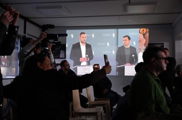 Journalists sitting in a press room follow a press conference of Greenland's Prime Minister Jens-Frederik Nielsen (C-L) and Greenland's Minister for Finance and Taxes Múte Bourup Egede (C-R) displayed on a screen in the background, on January 20, 2026 in Greenland's capital Nuuk. (Photo by Jonathan Nackstrand / AFP)