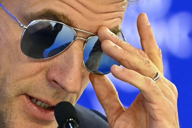France's President Emmanuel Macron adjusts his sunglasses as he delivers a speech during the World Economic Forum (WEF) annual meeting in Davos on January 20, 2026. The World Economic Forum takes place in Davos from January 19 to January 23, 2026. (Photo by Fabrice COFFRINI / AFP)