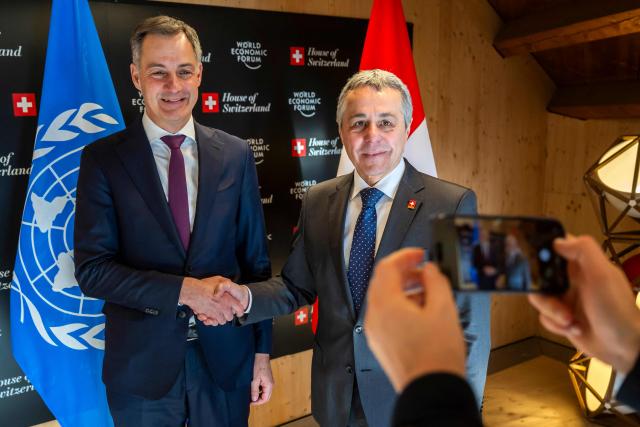 Administrator of the United Nations Development Programme (UNDP) Belgian Alexander De Croo (L) shakes hands with Switzerland's Foreign Minister Ignazio Cassis prior to a bilateral meeting during the World Economic Forum (WEF) annual meeting in Davos on January 20, 2026. The World Economic Forum takes place in Davos from January 19 to January 23, 2026. (Photo by LAURENT GILLIERON / POOL / AFP)