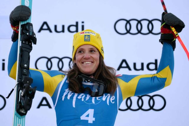 Sweden's Sara Hector, third placed, celebrates on the podium of the Women's Giant Slalom event of FIS Alpine Skiing World Cup in Kronplatz, Plan de Corones, Italy, on January 20, 2026. (Photo by Marco BERTORELLO / AFP)