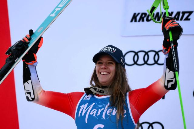 Switzerland's Camille Rast, second placed, celebrates on the podium of the Women's Giant Slalom event of FIS Alpine Skiing World Cup in Kronplatz, Plan de Corones, Italy, on January 20, 2026. (Photo by Marco BERTORELLO / AFP)