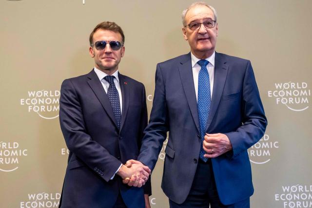 France's President Emmanuel Macron shakes hands with Switzerland's President Guy Parmelin prior to a bilateral meeting on the sidelines of the World Economic Forum (WEF) annual meeting in Davos on January 20, 2026. The World Economic Forum takes place in Davos from January 19 to January 23, 2026. (Photo by LAURENT GILLIERON / POOL / AFP)