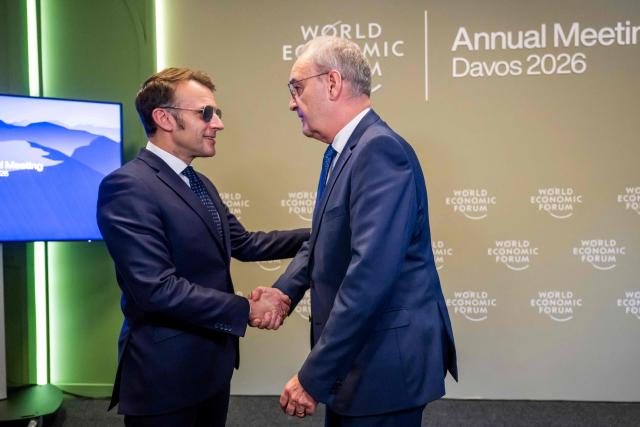 France's President Emmanuel Macron shakes hands with Switzerland's President Guy Parmelin prior to a bilateral meeting on the sidelines of the World Economic Forum (WEF) annual meeting in Davos on January 20, 2026. The World Economic Forum takes place in Davos from January 19 to January 23, 2026. (Photo by LAURENT GILLIERON / POOL / AFP)