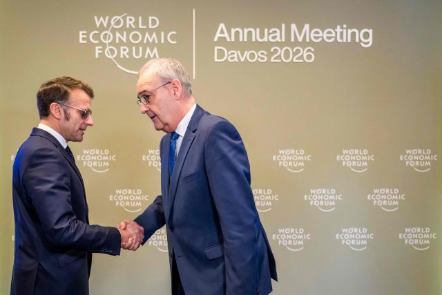 France's President Emmanuel Macron shakes hands with Switzerland's President Guy Parmelin prior to a bilateral meeting on the sidelines of the World Economic Forum (WEF) annual meeting in Davos on January 20, 2026. The World Economic Forum takes place in Davos from January 19 to January 23, 2026. (Photo by LAURENT GILLIERON / POOL / AFP)
