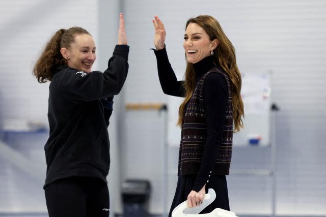 Britain's Catherine, Princess of Wales reacts with Scottish curler Jen Dodds while participating in curling, during a visit to meet with the Team GB and Paralympics GB Curling teams, ahead of the Winter Olympic Games, at the National Curling Academy in Stirling, in Scotland on January 20, 2026. (Photo by Russell Cheyne / POOL / AFP)