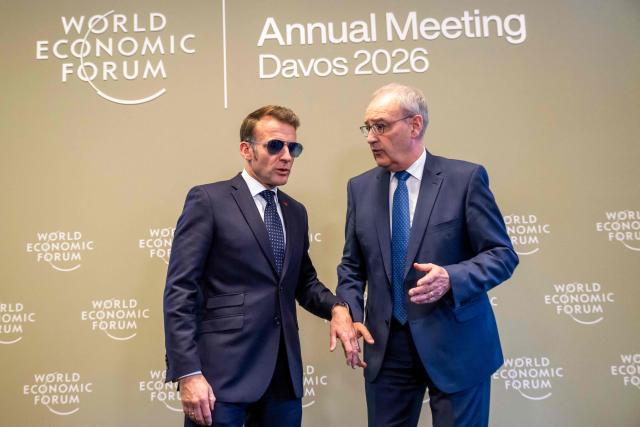 France's President Emmanuel Macron speaks with Switzerland's President Guy Parmelin prior to a bilateral meeting on the sidelines of the World Economic Forum (WEF) annual meeting in Davos on January 20, 2026. The World Economic Forum takes place in Davos from January 19 to January 23, 2026. (Photo by LAURENT GILLIERON / POOL / AFP)