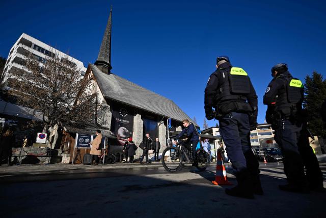 Police officers secure the perimeter around the USA House in Davos on the sidelines of the World Economic Forum (WEF) annual meeting in Davos on January 20, 2026. The World Economic Forum takes place in Davos from January 19 to January 23, 2026. (Photo by INA FASSBENDER / AFP)