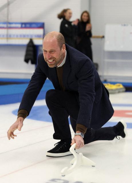 Britain's Prince William, Prince of Wales smiles while curling during a visit to meet with the Team GB and Paralympics GB Curling teams, ahead of the Winter Olympic Games, at the National Curling Academy in Stirling, in Scotland on January 20, 2026. (Photo by Russell Cheyne / POOL / AFP)
