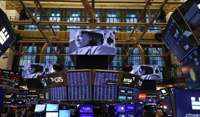 An image of Dr. Martin Luther King, Jr. is displayed on a screen as traders work on the floor of the New York Stock Exchange (NYSE) in New York on January 20, 2026. The New York Stock Exchange welcomed executives and guests of The Memorial Foundation in commemoration of Dr. Martin Luther King, Jr. Day and his 97th Birthday. (Photo by TIMOTHY A. CLARY / AFP)