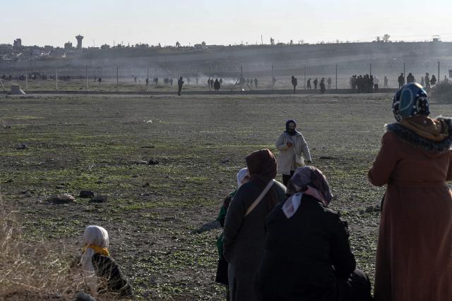 Protesters enter a buffer zone during a rally against an offensive of Syrian government forces against Kurdish forces, near Nusaybin border gate in Mardin, on the Turkey-Syria border, on January 20, 2026. Clashes erupted on Turkey's border with Syria on between police and pro-Kurdish protesters angered by a Syrian military offensive targeting Kurds, an AFP correspondent said. The violence broke out in the border town of Nusaybin, just across from the northern Syrian town of Qamishli, at a protest called by the pro-Kurdish DEM, Turkey's third-largest party. (Photo by Ilyas AKENGIN / AFP)