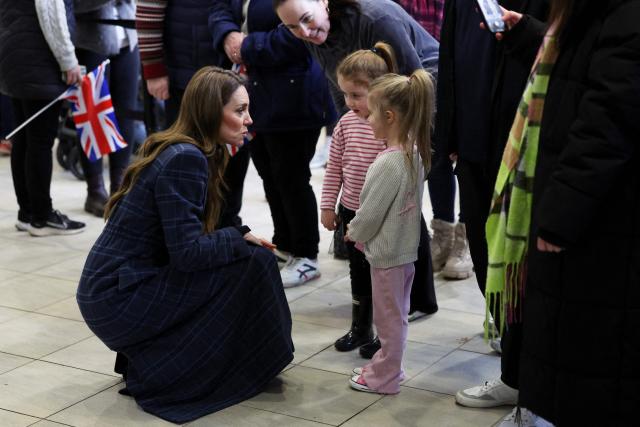 Britain's Catherine, Princess of Wales chats to a couple of young fans during her visit at the National Curling Academy in Stirling, in Scotland on January 20, 2026. (Photo by Russell Cheyne / POOL / AFP)