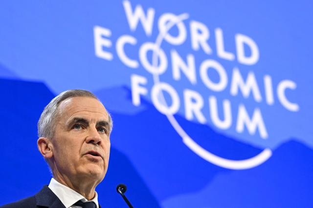 Canada's Prime Minister Mark Carney delivers a speech during the World Economic Forum (WEF) annual meeting in Davos on January 20, 2026. The World Economic Forum takes place in Davos from January 19 to January 23, 2026. (Photo by Fabrice COFFRINI / AFP)