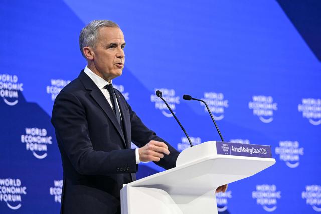 Canada's Prime Minister Mark Carney delivers a speech during the World Economic Forum (WEF) annual meeting in Davos on January 20, 2026. The World Economic Forum takes place in Davos from January 19 to January 23, 2026. (Photo by Fabrice COFFRINI / AFP)