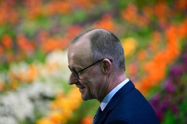 German Chancellor Friedrich Merz stands in front of a bed of flowers as he visits the house and garden section of the "Gruene Woche" (Green Week) International Agriculture Fair in Berlin on January 20, 2026. The 100th edition of the Green Week, one of the world's leading events in the food, agriculture and horticulture sectors, will be running from January 16 to 25, 2026, and some 1600 exhibitors from over 50 countries are presenting their products and services. (Photo by John MACDOUGALL / AFP)