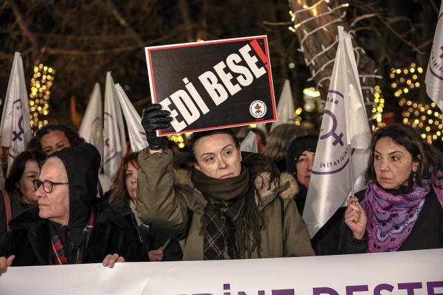 A woman holds a placard reading "enough" during a rally in Ankara, on January 20, 2026, against the offensive of Syrian government forces against Kurdish forces. Clashes erupted on Turkey's border with Syria on January 20 between police and pro-Kurdish protesters angered by a Syrian military offensive targeting Kurds, an AFP correspondent said. The violence broke out in the border town of Nusaybin, just across from the northern Syrian town of Qamishli, at a protest called by the pro-Kurdish DEM, Turkey's third-largest party. (Photo by Adem ALTAN / AFP)