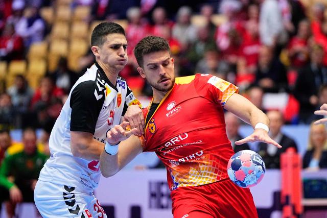 North Macedonia's left back #38 Ivan Dzonov (L) and Romania's left back #06 Tudor Botea vie for the ball during the EHF Euro 2026 Group B preliminary round handball match between North Macedonia and Romania in Herning, Denmark, on January 20, 2026. (Photo by Bo Amstrup / Ritzau Scanpix / AFP) / Denmark OUT