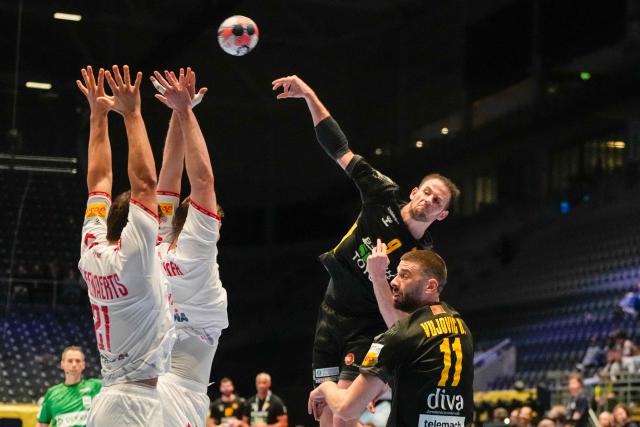 Montenegro's centre back #09 Radojica Cepic shoots over Switzerland's right winger #21 Gino Steenaerts during the EHF Euro 2026 group D preliminary round handball match between Montenegro and Switzerland in Baerum near Oslo, Norway, on January 20, 2026. (Photo by Erik Flaaris Johansen / NTB / AFP) / Norway OUT