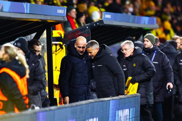 Manchester City's Spanish manager Pep Guardiola (L) greets Bodoe/Glimt's Norwegian head coach Kjetil Knutsen prior the UEFA Champions League, league Phase - day 7 football match between Bodoe/Glimt and Manchester City in Bodoe, Norway on January 20, 2026. (Photo by Mats Torbergsen / NTB / AFP) / Norway OUT