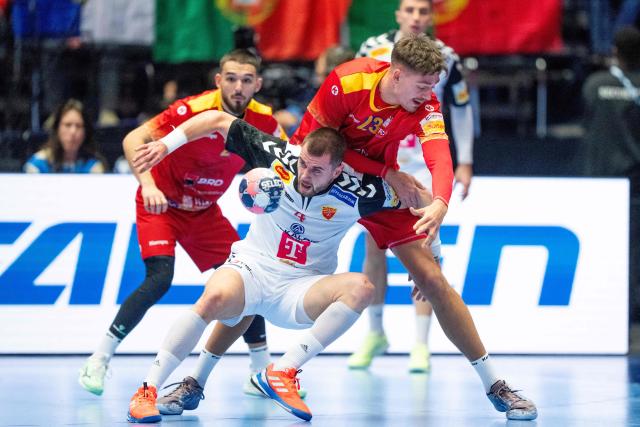 North Macedonia's right back #04 Martin Velkovski and Romania's pivot #23 Calin Dedu vie for the ball during the EHF Euro 2026 Group B preliminary round handball match between North Macedonia and Romania in Herning, Denmark, on January 20, 2026. (Photo by Bo Amstrup / Ritzau Scanpix / AFP) / Denmark OUT