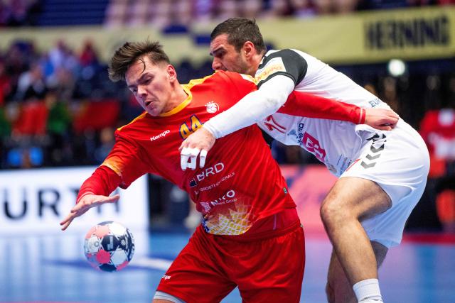 Romania's centre back #44 Daniel Stanciuc (L) and North Macedonia's pivot #17 Nikola Markovski vie for the ball during the EHF Euro 2026 Group B preliminary round handball match between North Macedonia and Romania in Herning, Denmark, on January 20, 2026. (Photo by Bo Amstrup / Ritzau Scanpix / AFP) / Denmark OUT
