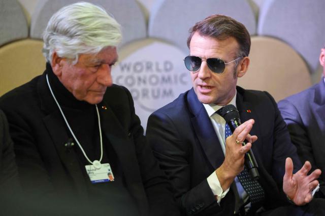 French businessman Maurice Levy and France's President Emmanuel Macron attend a meeting with CEOs of AI companies during the World Economic Forum (WEF) annual meeting in Davos on January 20, 2026. The World Economic Forum takes place in Davos from January 19 to January 23, 2026. (Photo by Ludovic MARIN / AFP)