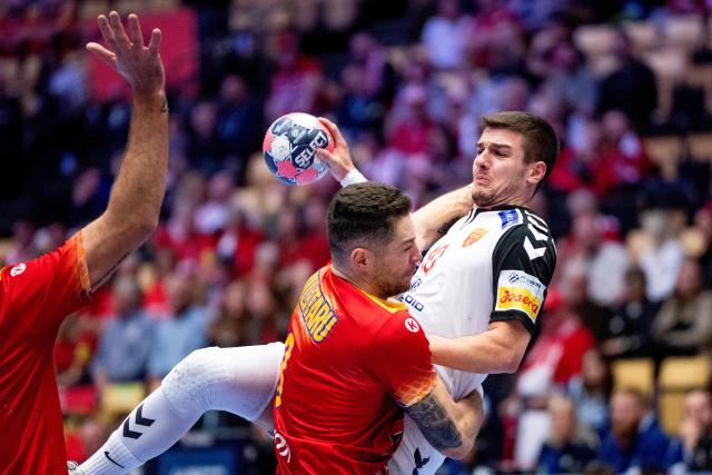 North Macedonia's centre back #10 Marko Mitev and Romania's left back #08 Robert Militaru vie during the EHF Euro 2026 Group B preliminary round handball match between North Macedonia and Romania in Herning, Denmark, on January 20, 2026. (Photo by Bo Amstrup / Ritzau Scanpix / AFP) / Denmark OUT