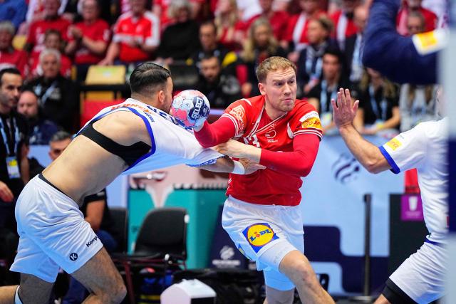 Denmark's centre back #43 Simon Pytlick (C) vies during the EHF Euro 2026 Group B preliminary round handball match between Denmark and Portugal in Herning, Denmark, on January 20, 2026. (Photo by Bo Amstrup / Ritzau Scanpix / AFP) / Denmark OUT