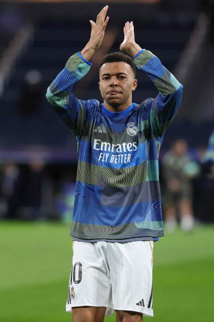 Real Madrid's French forward #10 Kylian Mbappe applauds during the warmup before the UEFA Champions League league phase day 7 football match between Real Madrid CF and AS Monaco at Santiago Bernabeu Stadium in Madrid on January 20, 2026. (Photo by Thomas COEX / AFP)