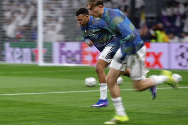 Real Madrid's French forward #10 Kylian Mbappe runs during the warmup before the UEFA Champions League league phase day 7 football match between Real Madrid CF and AS Monaco at Santiago Bernabeu Stadium in Madrid on January 20, 2026. (Photo by Thomas COEX / AFP)