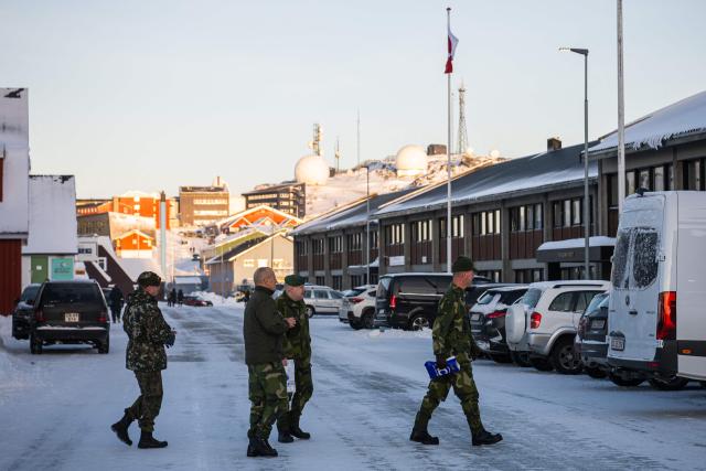 Soldiers cross a street in Nuuk, Greenland, on January 20, 2026. (Photo by Jonathan NACKSTRAND / AFP)