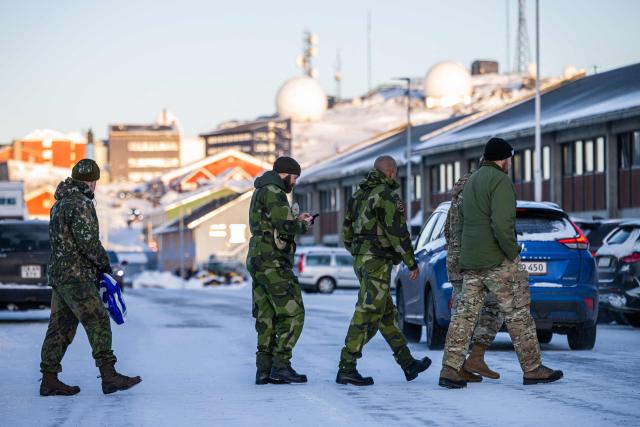 Soldiers cross a street in Nuuk, Greenland, on January 20, 2026. (Photo by Jonathan NACKSTRAND / AFP)