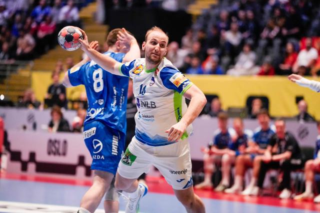 Slovenia's centre back #14 Domen Tajnik shoots during the EHF Euro 2026 group D preliminary round handball match between Slovenia and Faroe Islands in Baerum near Oslo, Norway, on January 20, 2026. (Photo by Erik Flaaris Johansen / NTB / AFP) / Norway OUT