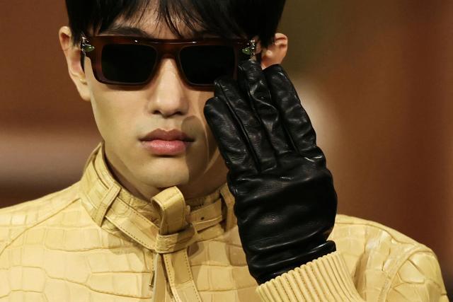 A model presents sunglasses and gloves by Louis Vuitton Menswear Ready-to-wear Fall-Winter 2026/2027 collection as part of the Paris Fashion Week in Paris on January 20, 2026. (Photo by Thomas SAMSON / AFP)
