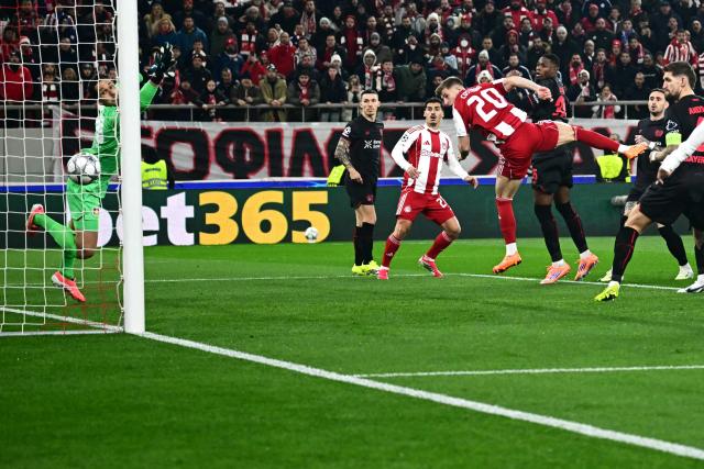 Olympiakos' Portuguese defender #20 Costinha heads the ball and score his team's first goal during the during the UEFA Champions League, league phase day 7, football match between Olympiakos and Bayer Leverkusen at the Georgios Karaiskakis Stadium in Piraeus, near Athens, on January 20, 2026. (Photo by Aggelos NAKKAS / AFP)