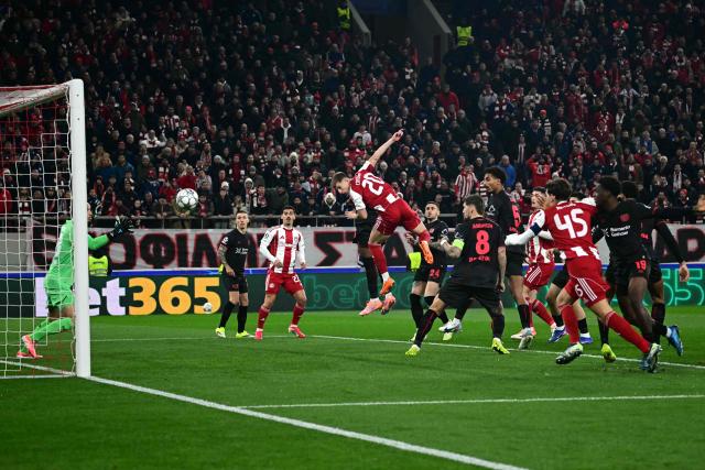 Olympiakos' Portuguese defender #20 Costinha heads the ball and score his team's first goal during the during the UEFA Champions League, league phase day 7, football match between Olympiakos and Bayer Leverkusen at the Georgios Karaiskakis Stadium in Piraeus, near Athens, on January 20, 2026. (Photo by Aggelos NAKKAS / AFP)