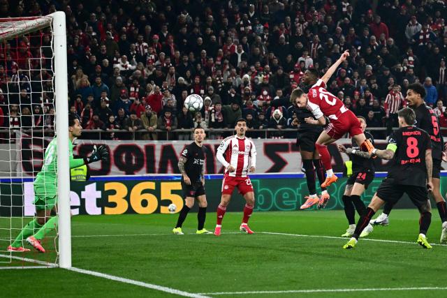 Olympiakos' Portuguese defender #20 Costinha heads the ball and score his team's first goal during the during the UEFA Champions League, league phase day 7, football match between Olympiakos and Bayer Leverkusen at the Georgios Karaiskakis Stadium in Piraeus, near Athens, on January 20, 2026. (Photo by Aggelos NAKKAS / AFP)