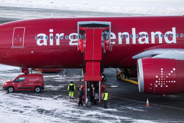 Greenland’s Foreign Minister Vivian Motzfeldt waves to locals after arriving on an Air Greenland aircraft at Nuuk Airport, Greenland, on January 20, 2026. (Photo by Jonathan NACKSTRAND / AFP)