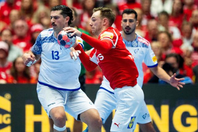 Portugal's left back #13 Salvador Salvador and Denmark's right back #19 Mathias Gidsel vie during the EHF Euro 2026 Group B preliminary round handball match between Denmark and Portugal in Herning, Denmark, on January 20, 2026. (Photo by Bo Amstrup / Ritzau Scanpix / AFP) / Denmark OUT