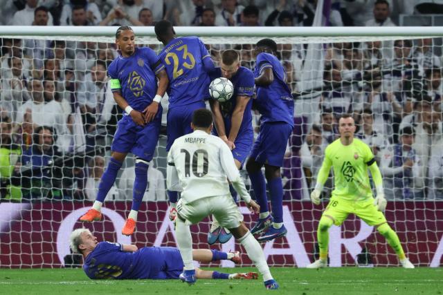 Real Madrid's French forward #10 Kylian Mbappe takes a free kick during the UEFA Champions League league phase day 7 football match between Real Madrid CF and AS Monaco at Santiago Bernabeu Stadium in Madrid on January 20, 2026. (Photo by Pierre-Philippe MARCOU / AFP)