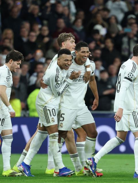 Real Madrid's English midfielder #05 Jude Bellingham (C) celebrates scoring his team's sixth goal with Real Madrid's French forward #10 Kylian Mbappeduring the UEFA Champions League league phase day 7 football match between Real Madrid CF and AS Monaco at Santiago Bernabeu Stadium in Madrid on January 20, 2026. (Photo by Thomas COEX / AFP)