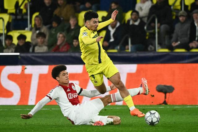 Ajax's Dutch defender #30 Aaron Bouwman (L) and Villarreal's French forward #09 Georges Mikautadze (R) fight for the ball during the UEFA Champions League league phase day 7 football match between Villarreal CF and Ajax at La Ceramica Stadium in Vila-real on January 20, 2026. (Photo by JOSE JORDAN / AFP)