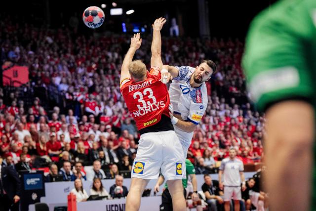 Portugal's left back #20 Miguel Neves shoots the ball past Denmark's pivot #33 Emil Bergholt during the EHF Euro 2026 Group B preliminary round handball match between Denmark and Portugal in Herning, Denmark, on January 20, 2026. (Photo by Sebastian Elias Uth / Ritzau Scanpix / AFP) / Denmark OUT