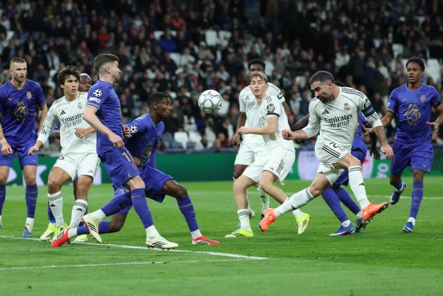 Real Madrid's Spanish defender #02 Dani Carvajal (R) heads the ball during the UEFA Champions League league phase day 7 football match between Real Madrid CF and AS Monaco at Santiago Bernabeu Stadium in Madrid on January 20, 2026. (Photo by Thomas COEX / AFP)