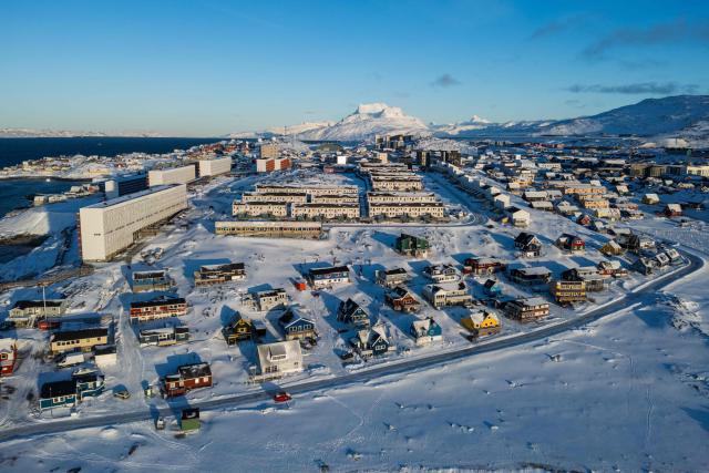 This aerial view image shows the city of Nuuk covered in snow along the coastline of western Greenland, on January 20, 2026. (Photo by Jonathan NACKSTRAND / AFP)