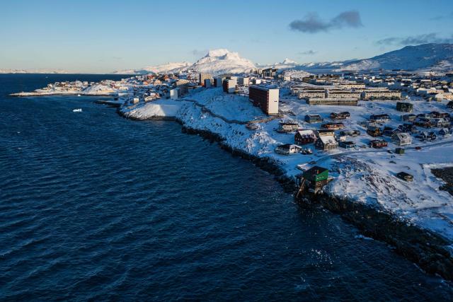 This aerial view image shows the city of Nuuk covered in snow along the coastline of western Greenland, on January 20, 2026. (Photo by Jonathan NACKSTRAND / AFP)