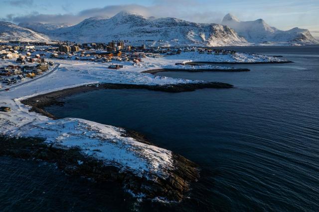 This aerial view image shows the city of Nuuk covered in snow along the coastline of western Greenland, on January 20, 2026. (Photo by Jonathan NACKSTRAND / AFP)
