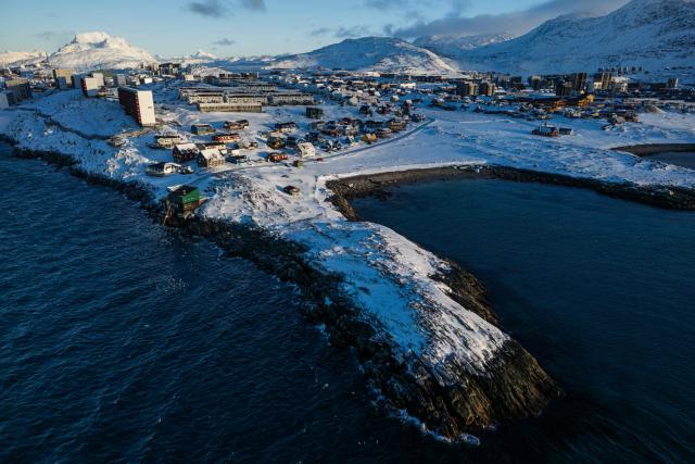 This aerial view image shows the city of Nuuk covered in snow along the coastline of western Greenland, on January 20, 2026. (Photo by Jonathan NACKSTRAND / AFP)