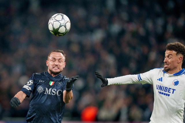 Napoli's Slovak midfielder #68 Stanislav Lobotka heads the ball next to and FC Copenhagen's Swedish forward #11 Jordan Larsson during the UEFA Champions League, league phase day 7, football match between FC Copenhaben and SSC Napoli in Copenhagen on January 20, 2026. (Photo by Liselotte Sabroe / Ritzau Scanpix / AFP) / Denmark OUT