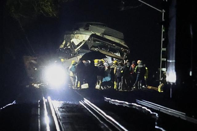 Firefighters and rescue personnel work at the site where at least one person died and four were seriously injured when a regional service train collided with a collapsed wall  between Sant Sadurni d'Anoia and Gelida, near Barcelona, early January 21, 2026. The latest incident is likely to raise more questions about Spanish rail safety after the collision of two high-speed trains in the southern region of Andalusia on Sunday killed 42 people and injured more than 120.  (Photo by Josep LAGO / AFP)