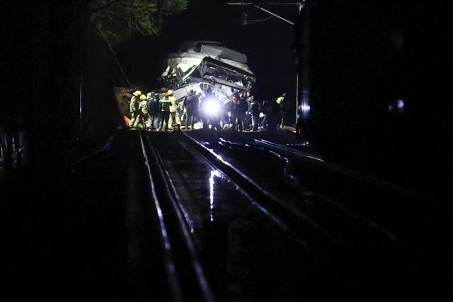 Firefighters and rescue personnel work at the site where at least one person died and four were seriously injured when a regional service train collided with a collapsed wall  between Sant Sadurni d'Anoia and Gelida, near Barcelona, early January 21, 2026. The latest incident is likely to raise more questions about Spanish rail safety after the collision of two high-speed trains in the southern region of Andalusia on Sunday killed 42 people and injured more than 120.  (Photo by Josep LAGO / AFP)